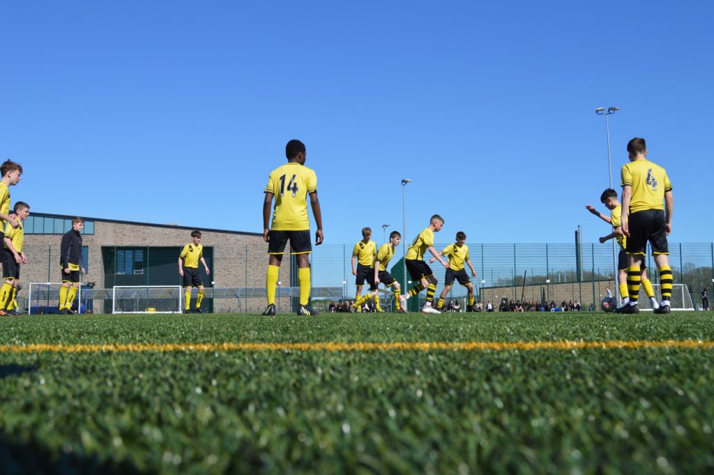 A group of boys play football at Perth Grammar School