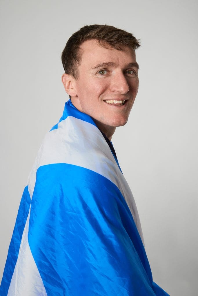 Jake Wightman wrapped in a Saltire flag